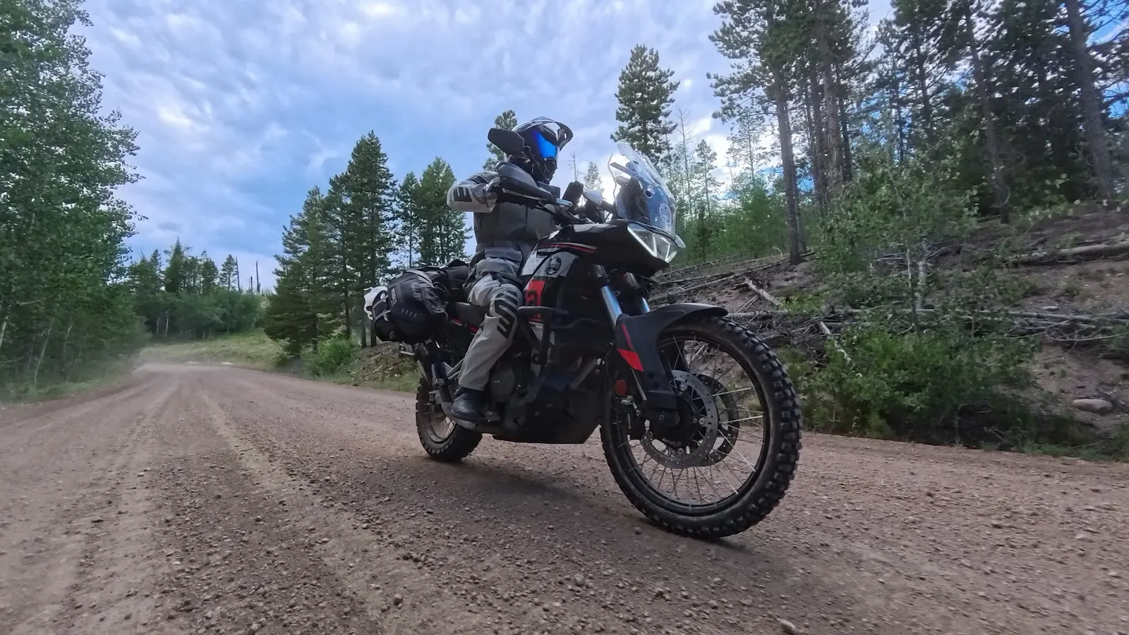 The Aprilia Tuareg 660 riding a Colorado gravel trail in low evening light after a long day