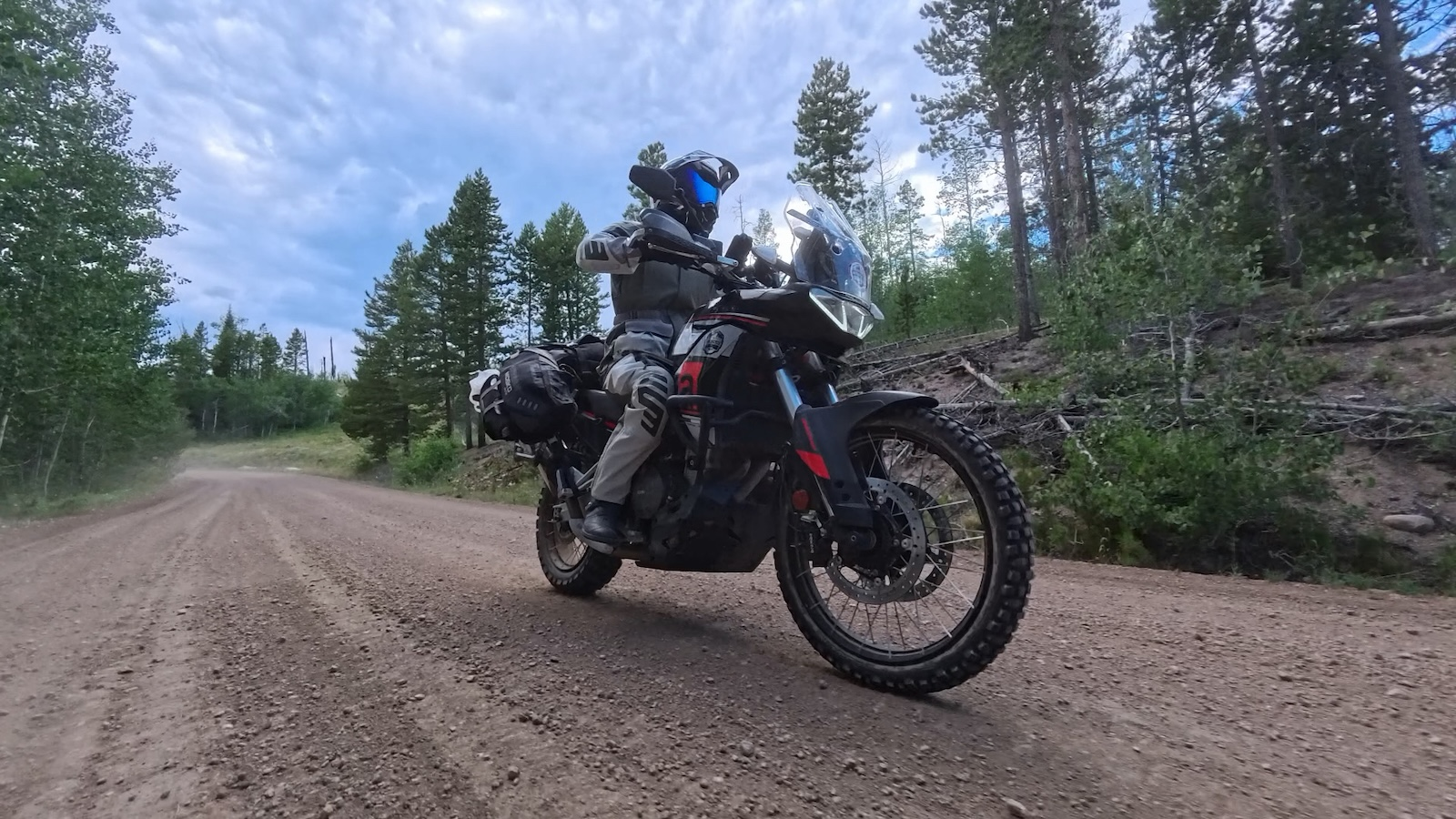 The Aprilia Tuareg 660 riding a Colorado gravel trail in low evening light after a long day