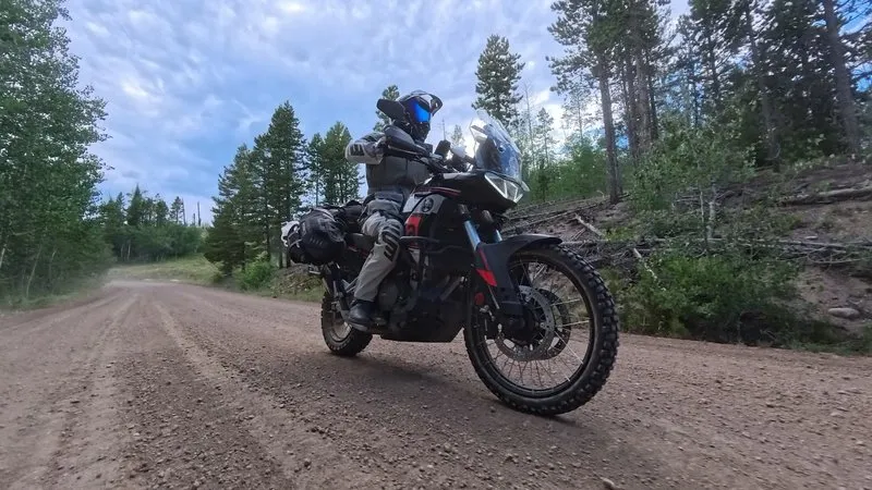 The Aprilia Tuareg 660 riding a Colorado gravel trail in low evening light