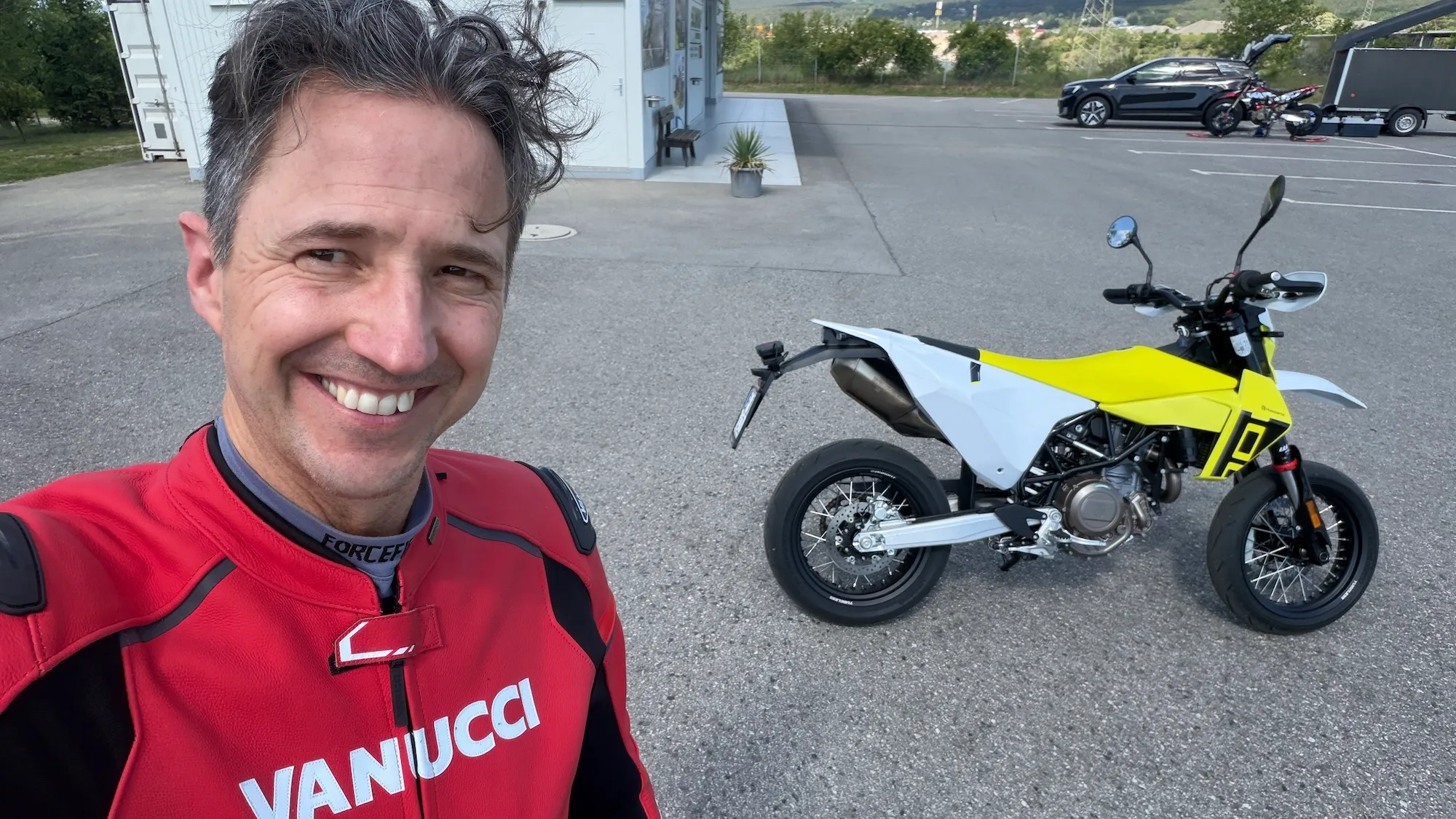 NastyNils selfie with the Husqvarna 701 Supermoto MY2026 in white/yellow livery at Motorsport Arena Austria, Bestzeit Produktionstag.