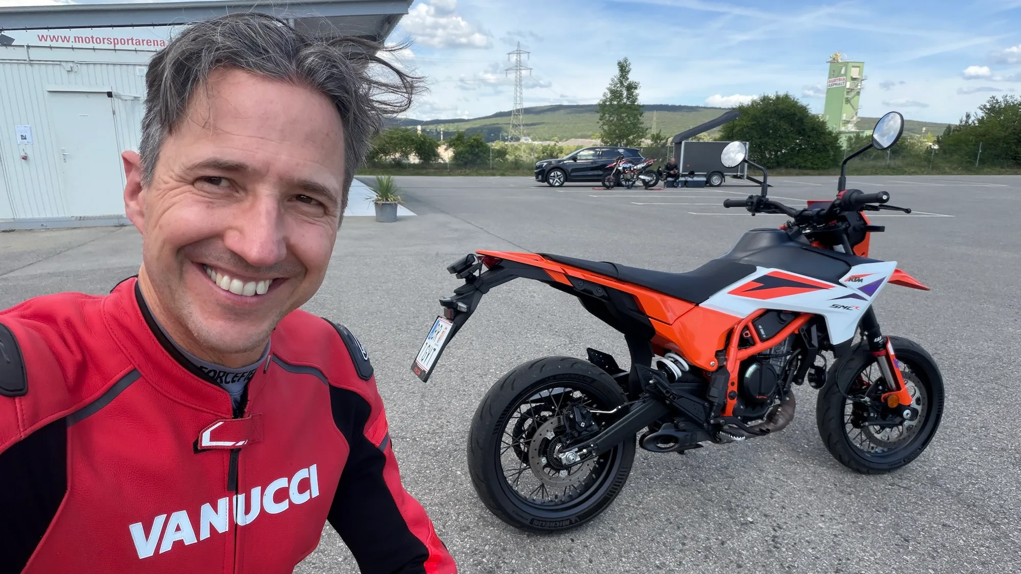 NastyNils selfie with the KTM 390 SMC R MY2026 in orange/white at Motorsportarena Austria, Bestzeit Produktionstag.