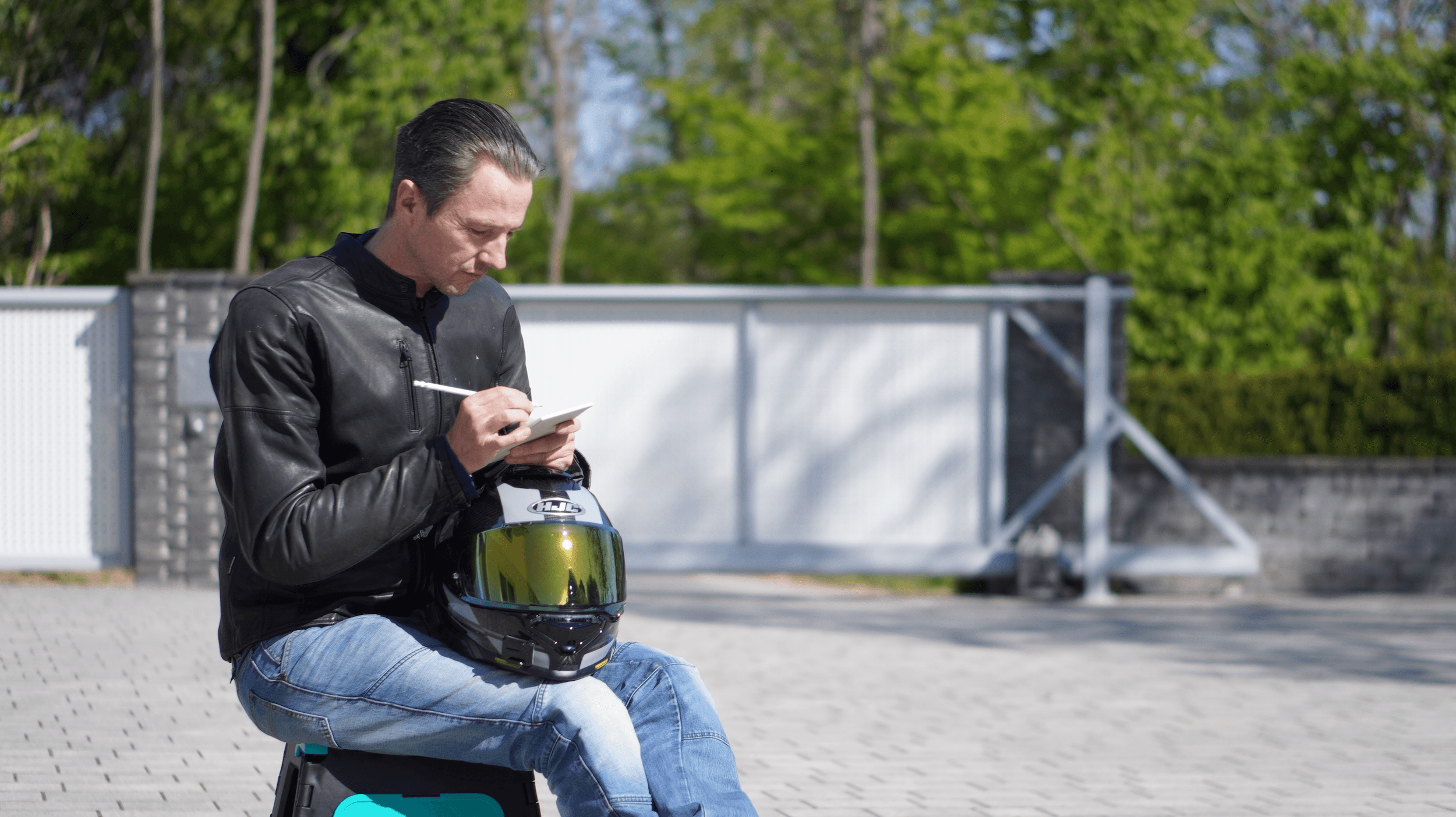 Nils in a leather jacket and jeans next to a sport-tourer / naked-bike lineup — the buyer's stance most used-bike guides forget to teach.