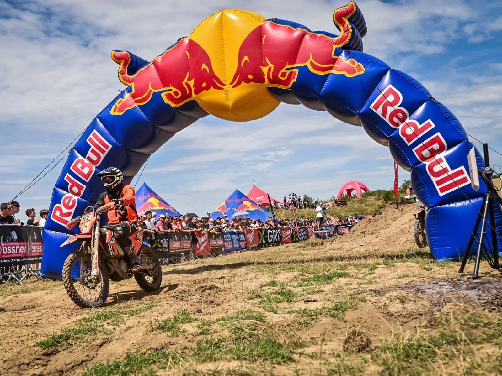 A KTM hard-enduro rider at the Red Bull Romaniacs start arch in Romania's Southern Carpathians.